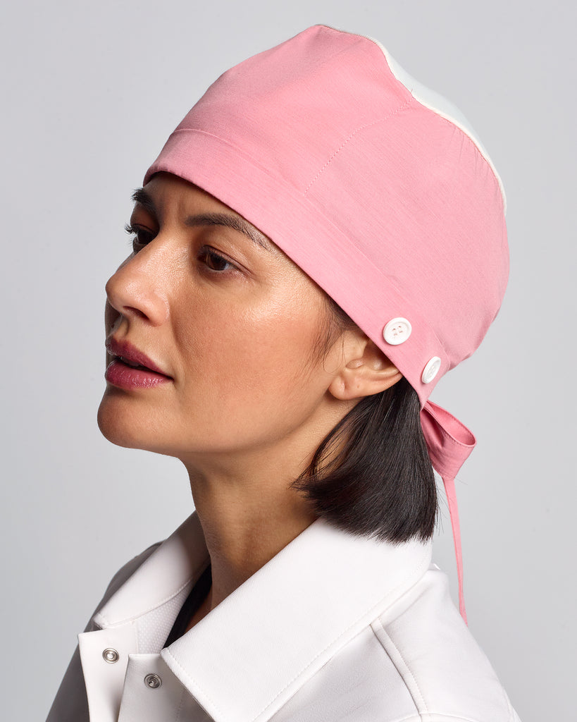 Woman wearing a pink surgical cap made by L'Atelier Forte